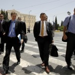 ECB's Masuch, EC's Deroose and IMF's Thomsen cross a street in front of the parliament in Athens