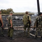 Armed pro-Russian separatists stand at the site of a Malaysia Airlines Boeing 777 plane crash near the settlement of Grabovo in the Donetsk region